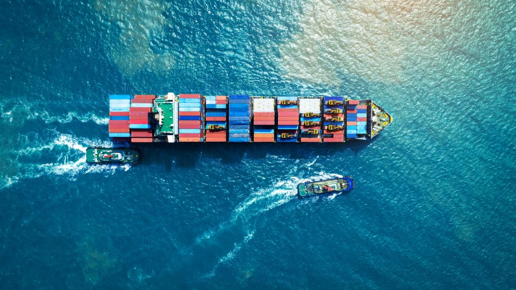 Cargo Container Ship running with with Tugboat. container ship import export